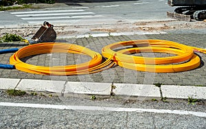 Long coils of orange plastic pipes