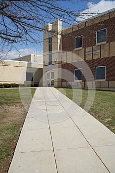 Long concrete sidewalk by a school