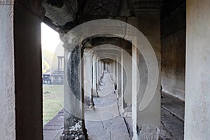 A long corridor with a colonnade. Old, abandoned building of the Khmer Empire