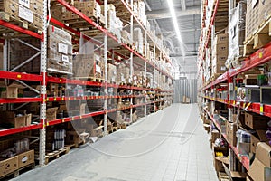 long corridor between high racks at the logistics center