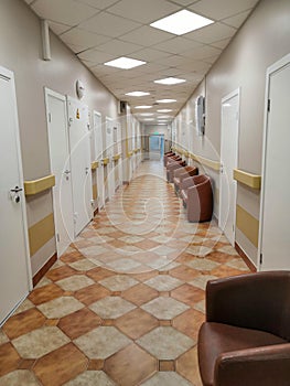 Long corridor in hospital with doors and reflections