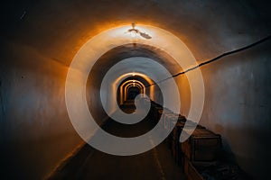 Long corridor or illuminated tunnel in bomb shelter, underground military bunker of cold war, perspective