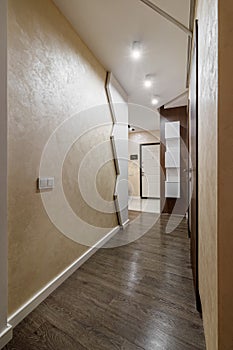 Long corridor with interior doors in an ordinary small apartment