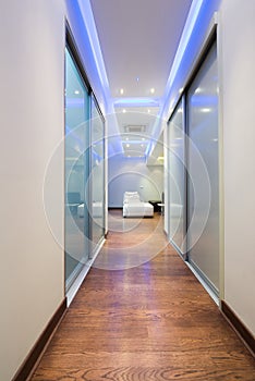 Long corridor in luxury apartment with colorful ceiling lights