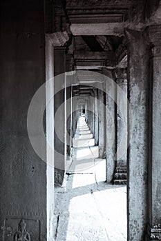 Long corridor of pillars in temple ruins, Angkor Wat in Cambodia