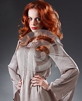 Long Curly Red Hair. Fashion Woman Portrait. Beauty Model Girl with Luxurious Hair, Make up and Accessories. Hairstyle