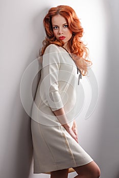 Long Curly Red Hair. Fashion Woman Portrait. Beauty Model Girl with Luxurious Hair, Make up and Accessories. Hairstyle