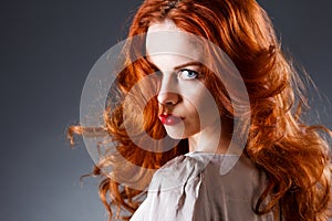 Long Curly Red Hair. Fashion Woman Portrait. Beauty Model Girl with Luxurious Hair, Make up and Accessories. Hairstyle