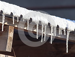 Long and dangerous icicles on a house roof