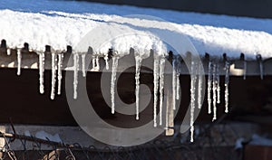 Long and dangerous icicles on a house roof