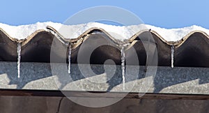 Long and dangerous icicles on a house roof