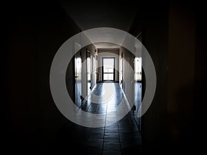 Long dark corridor with doors to the apartments