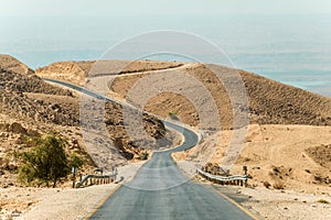 Long desert road stretching. empty asphalt road in the middle of desert with the nature of the middle East