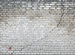 Long diagonal crack in a brick wall