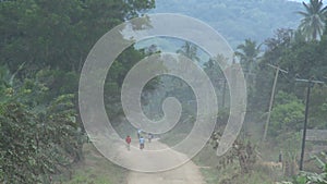 Long dirt road in africa with bicycles