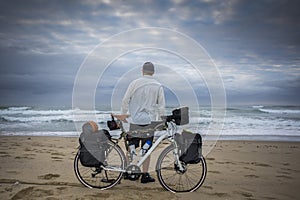 Long Distance Cyclist on beach with Bicycle