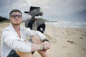 Long Distance Cyclist on Beach Bicycle Behind Him.