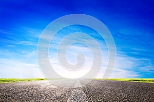 Long empty asphalt road, highway towards sun