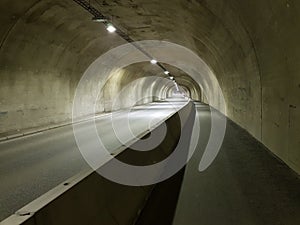 Long empty car concrete tunnel in the wintertime