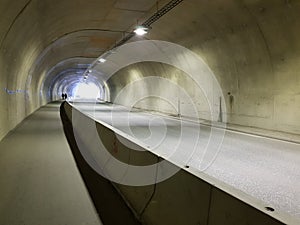 Long empty car concrete tunnel in the wintertime