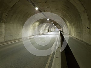 Long empty car concrete tunnel in the wintertime