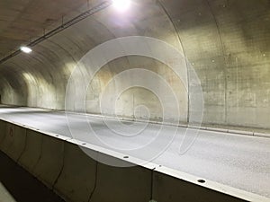 Long empty car concrete tunnel in the wintertime