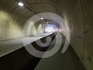 Long empty car concrete tunnel in the wintertime