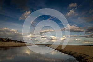 Long, empty and clean sand Stogi beach in the sunset near Gdansk, Poland with dramatic blue sky