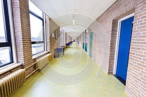 Long empty corridor in high school building photo