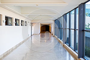 Long empty corridor with large glass windows. Modern corridor. Commercial architecture