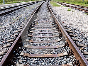 Long empty railroad tracks go into the distance, travel concept