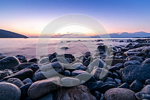 Long exposed photo of stones in the water of Mediterranean sea a