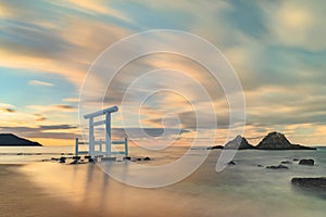 Long exposure art photography of a sunset seascape depicting the Couple Rocks of Sakurai Futamigaura and their torii.