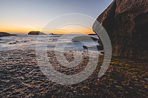 Long exposure of Atlantic ocean at sunset with rocks