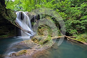 Long exposure of the beautiful La Vaioaga waterfall with green moss, Beusnita, Cheile Nerei National Park, Caras Severin, Romania