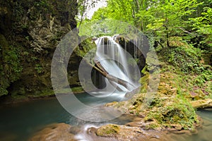 Long exposure of the beautiful La Vaioaga waterfall with green moss, Beusnita, Cheile Nerei National Park, Caras Severin, Romania