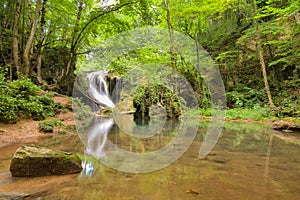 Long exposure of the beautiful La Vaioaga waterfall with green moss, Beusnita, Cheile Nerei National Park, Caras Severin, Romania