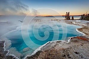 Long exposure of Black Pool at West Thumb Geyser Basin Trail during wonderful colorful sunset, Yellowstone National Park