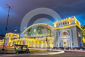 Long exposure, car lights running, tricycle parked in front of Bangkok Railway Station