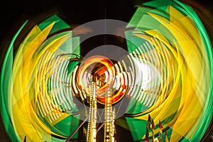 Long exposure of a carnival ride in action with bright colors