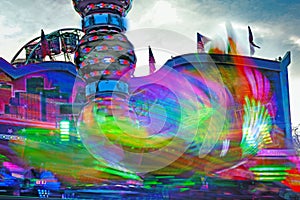 Long exposure of a carnival ride in fast motion at a Christmas fair, colorful abstract image
