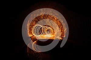 Long exposure of circle swirl in black tunnel