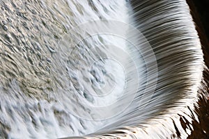 Long exposure of clean water running from taps with sparkling drops