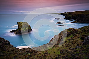 Long exposure Cliffs and basalt rocks in Arnarstapi, Snaefellsnes peninsula in Iceland.