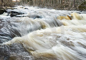 Long exposure closeup of a small gushing waterfall in a forest