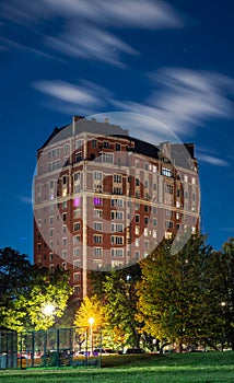 Long exposure of clouds moving across a dark blue sky over a highrise residential building in the Lakeview neighborhood along Lake photo