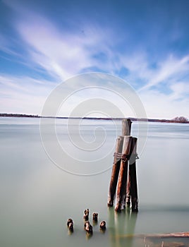 Long exposure daytime stock photo of wooden pylons in Lake Erie
