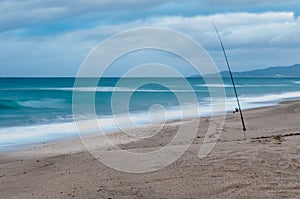 Long exposure of fishing pole on a beach in winter