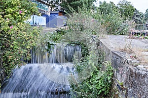 Long exposure of flowing water in stream in Cambridge, England, UK