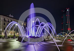 A long exposure if the Four seasons fountain in Milan and the giant by night